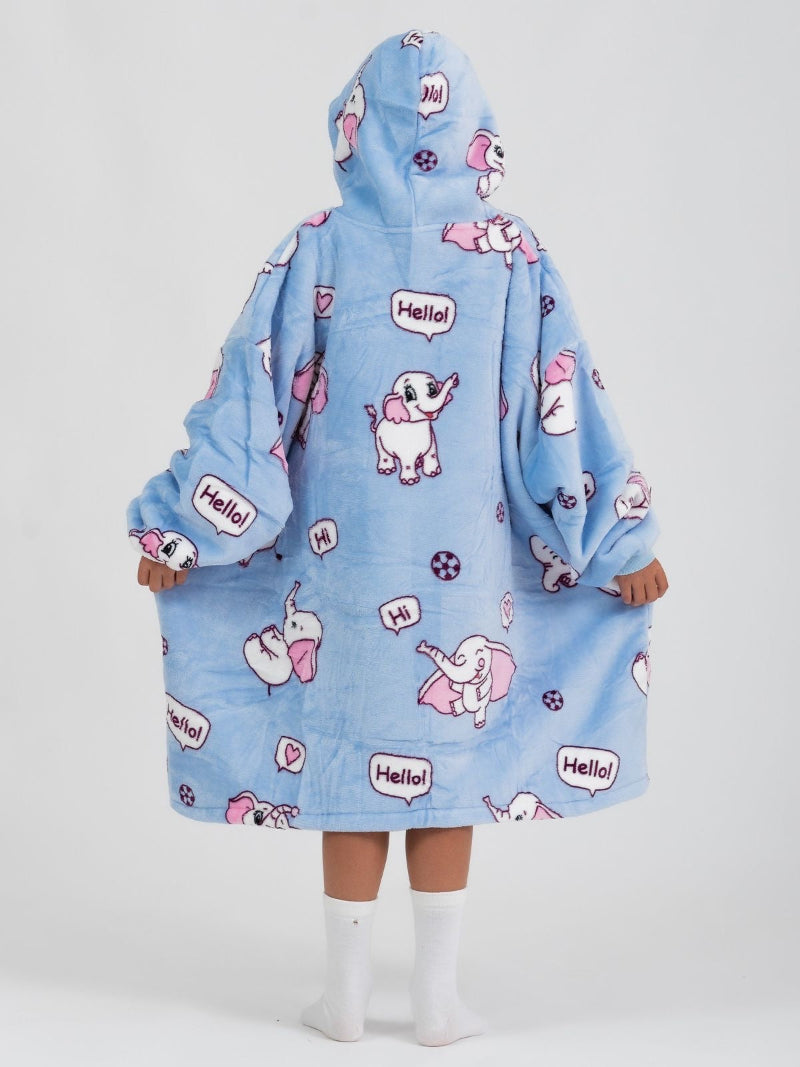 Back view of a child wearing a blue Cozify wearable blanket hoodie featuring pink and white cartoon elephants, speech bubbles with "Hello!" and "Hi!", and playful paw print accents.