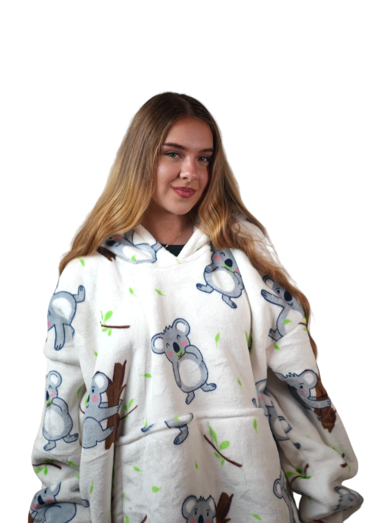 Cozify oversized wearable blanket hoodie in cream with a playful koala bear print, shown in a medium close-up view against a white background.