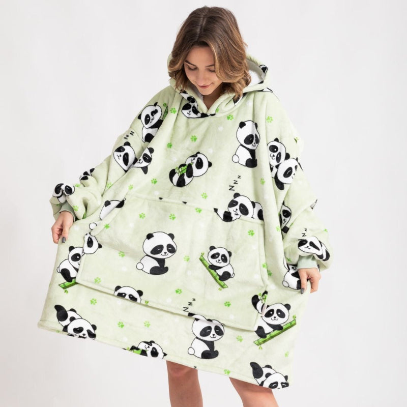 Front view of a person wearing a light green oversized hoodie with adorable panda and bamboo illustrations, featuring a large front pocket and hood, person looking down and holding the sides of the hoodie.