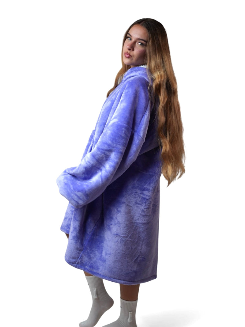 Cozify oversized wearable blanket hoodie in lavender purple with a cozy sherpa lining, shown from a side profile on a woman with long hair against a white background.