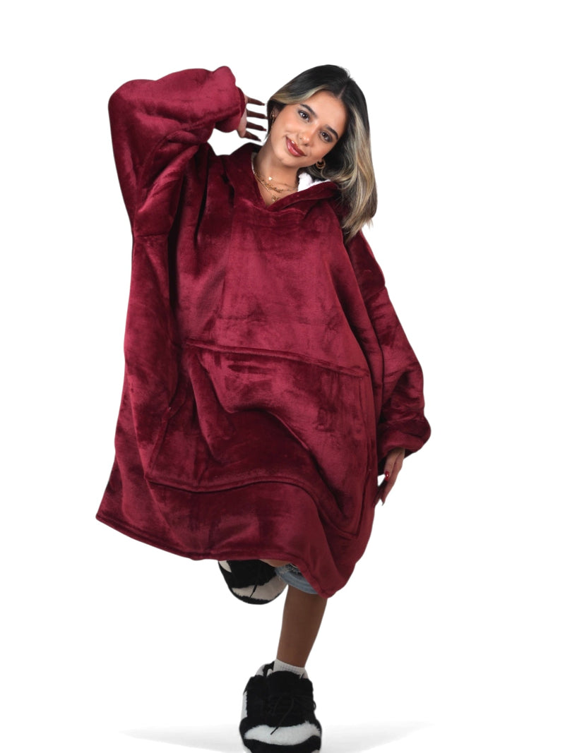 Woman wearing a burgundy oversized wearable blanket hoodie with sherpa fleece lining, large pocket and hood – soft plush winter loungewear perfect for cozy comfort or gifting in Lebanon