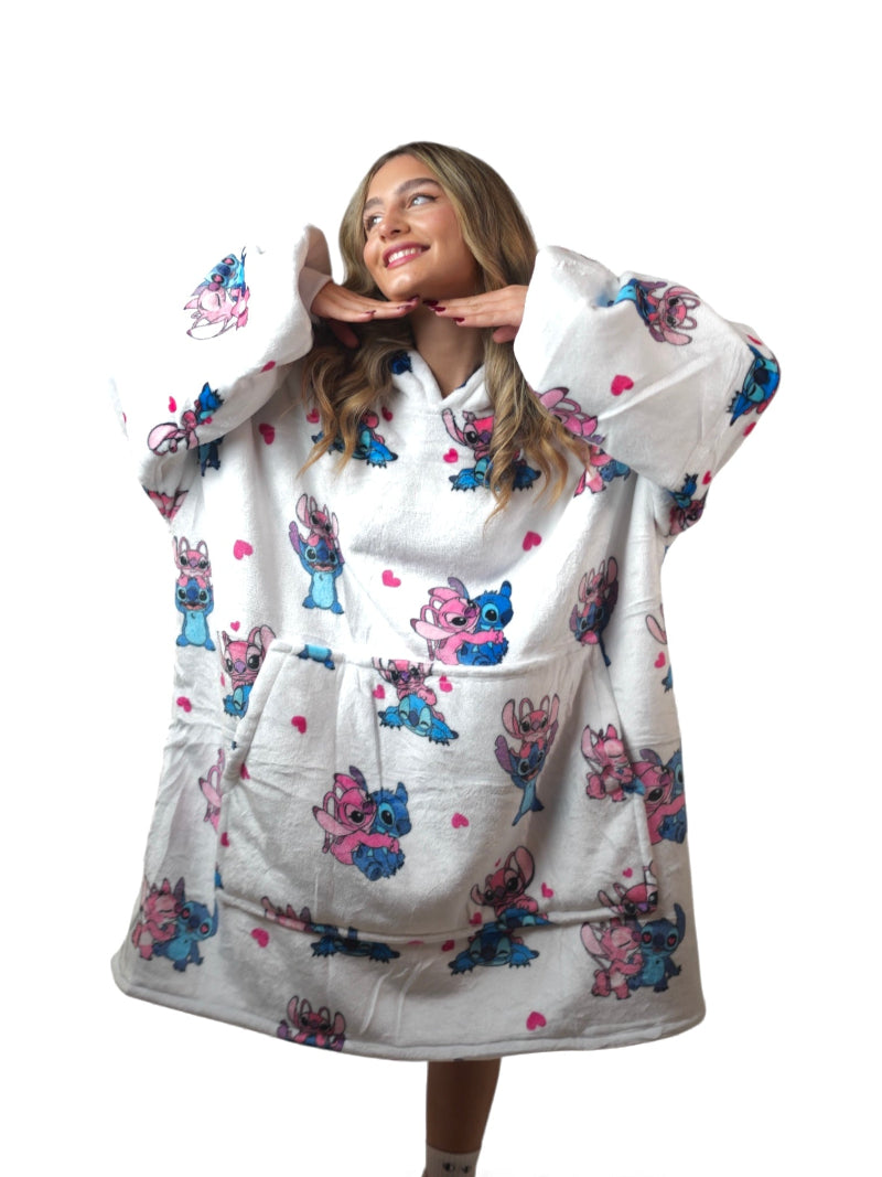 Woman wearing a white oversized wearable blanket hoodie with Stitch and Angel cartoon print, featuring sherpa fleece lining, hood and large pocket – cozy Disney-style loungewear for women and teens, ideal for winter comfort or gifting in Lebanon