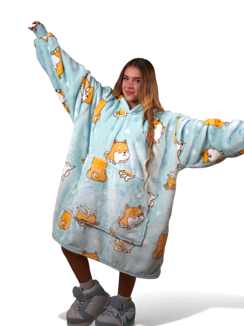 Navy blue sherpa-lined oversized wearable blanket hoodie with a front kangaroo pocket and a cartoon dog print, laid flat on a white background.