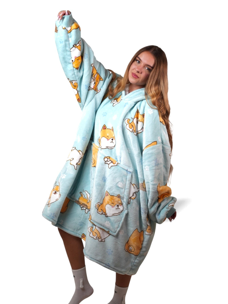 Light pink sherpa-lined oversized wearable blanket hoodie featuring a playful dog print, shown against a white background.