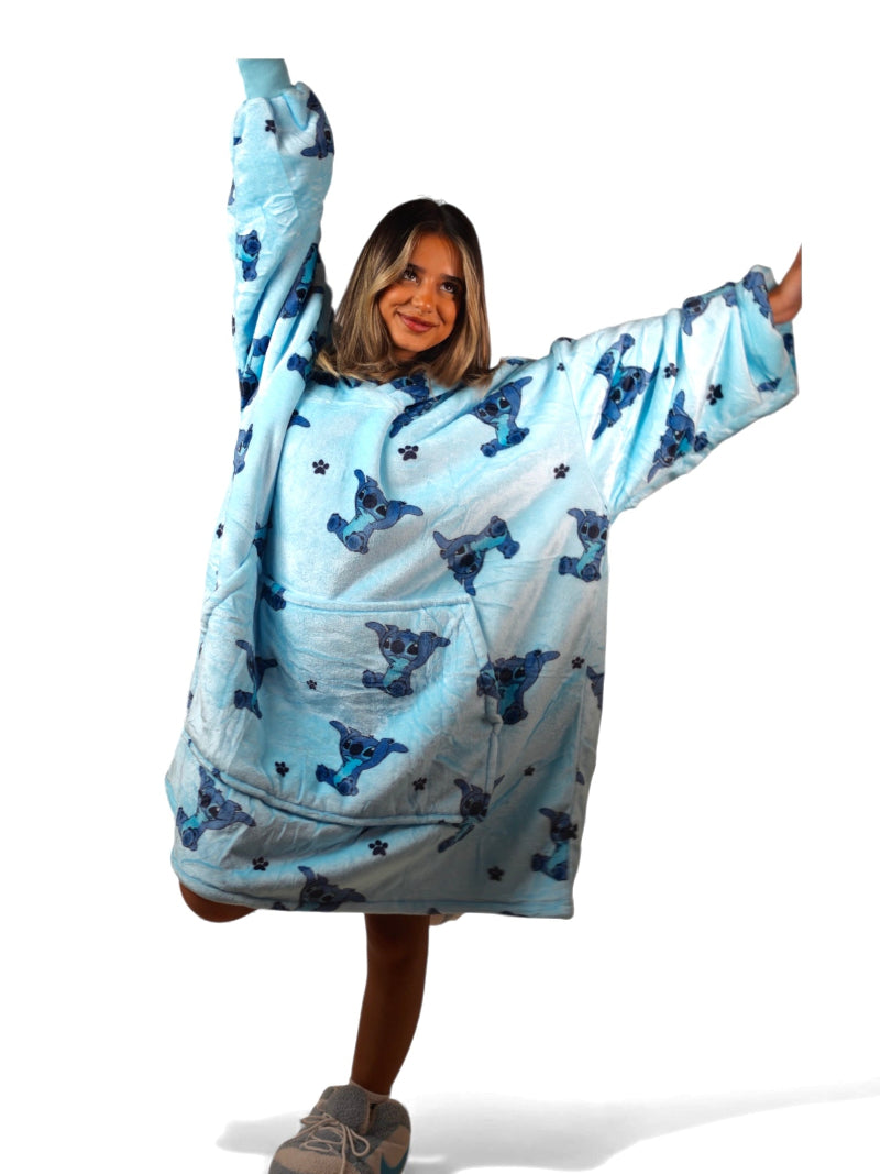 Soft pink sherpa-lined oversized wearable blanket hoodie featuring a playful Stitch character print and a front kangaroo pocket, laid flat on a white background.