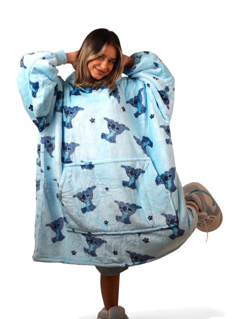 Pastel purple sherpa-lined oversized wearable blanket hoodie featuring a playful Stitch character print and a front kangaroo pocket, laid flat on a white background.